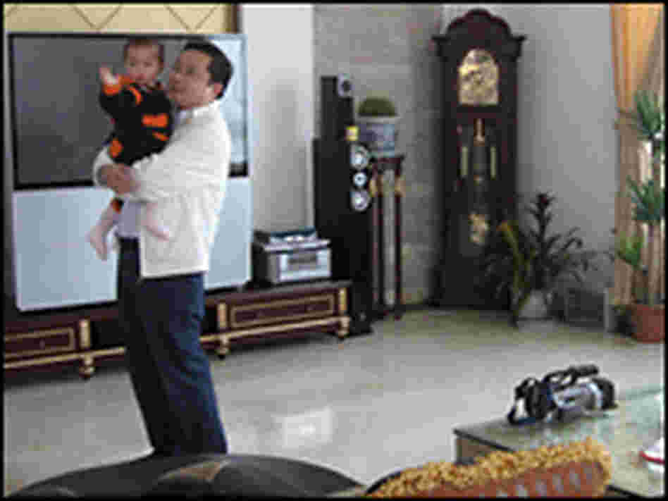 Sun Haiyan with his son in his opulent Huaxi home. 