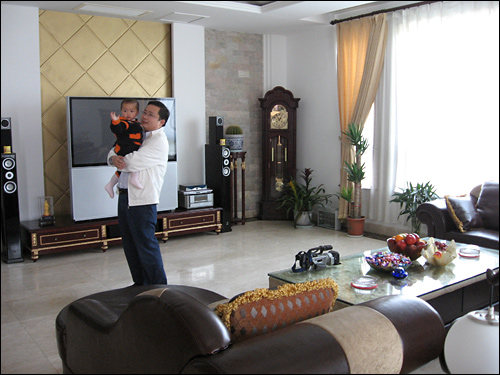 Sun Haiyan with his son in his opulent Huaxi home. 