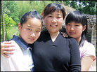 Wu Dexiu has lived apart from her daughters, Tang Deyun, left, and Tang Shanshan for nine years. Wu Dexiu has lived apart from her daughters, Tang Deyun, left, and Tang Shanshan for nine years.