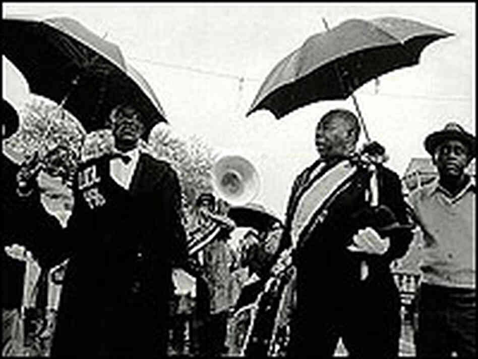 Detail from the cover of 'Our New Orleans' shows musicians at a funeral in the rain. Detail from the cover of 'Our New Orleans' shows musicians at a funeral in the rain.