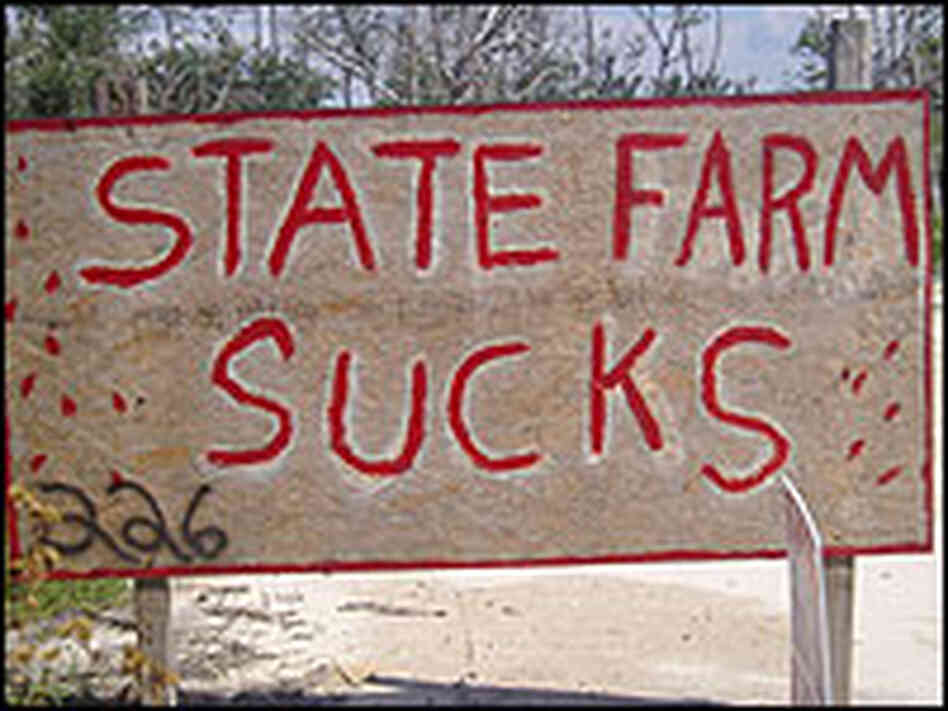 A sign reading, "State Farm Sucks." A sign reading, "State Farm Sucks."