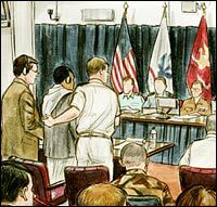 Salim Ahmed Hamdan, second from left, appears with appointed council Lt. Cmdr. Charles Swift, third from left, during a preliminary hearing at Guantanamo Bay, Cuba, Aug. 24, 2004.