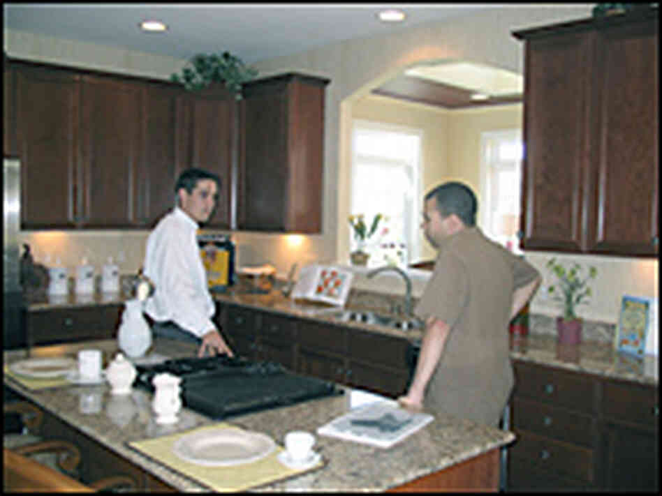 Mark Rathbun (left) tours a model home with Jose Weeks (right) Mark Rathbun (left) tours a model home with Jose Weeks (right)