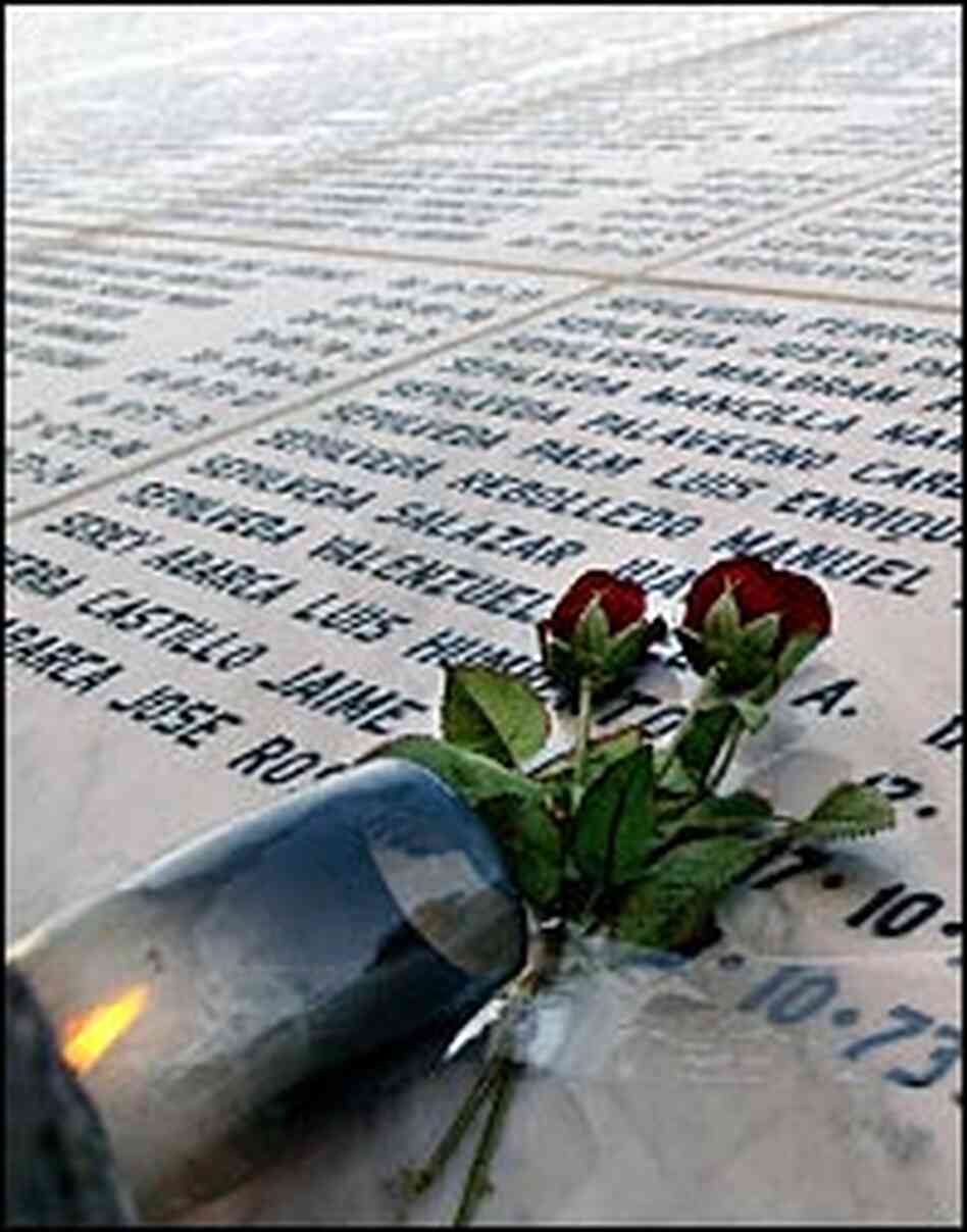 A candle and flowers left at a memorial for those who 'disappeared' under Pinochet's rule. A candle and flowers left at a memorial for those who 'disappeared' under Pinochet's rule.
