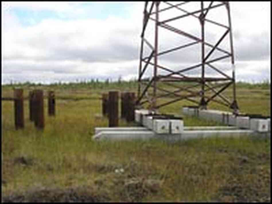 Pylons holding electric wires are being moved from tilting piles driven into the melting permafrost.
