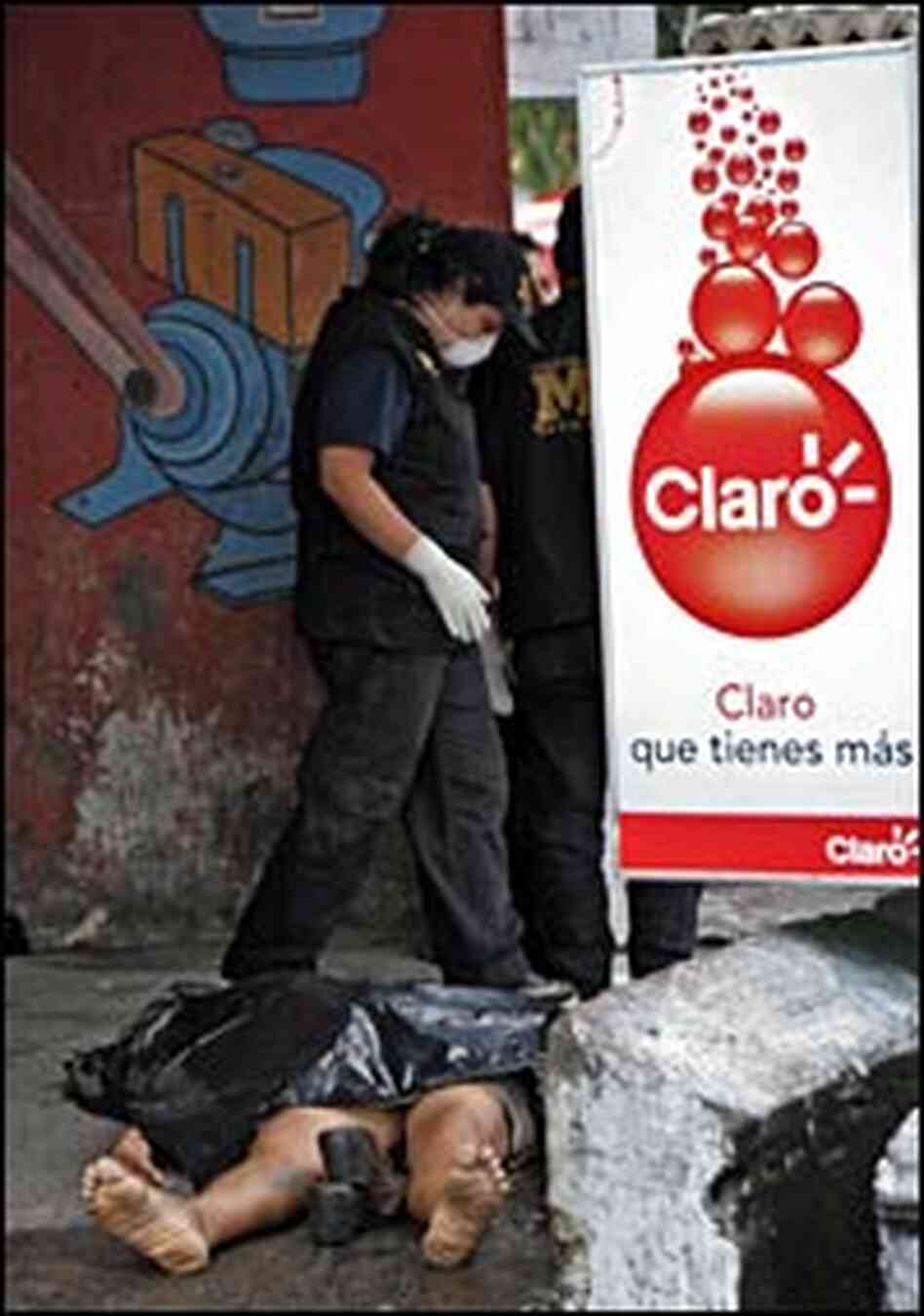 A public ministry officer looks at a murdered woman in Guatemala City in September 2006. A public ministry officer looks at a murdered woman in Guatemala City in September 2006.