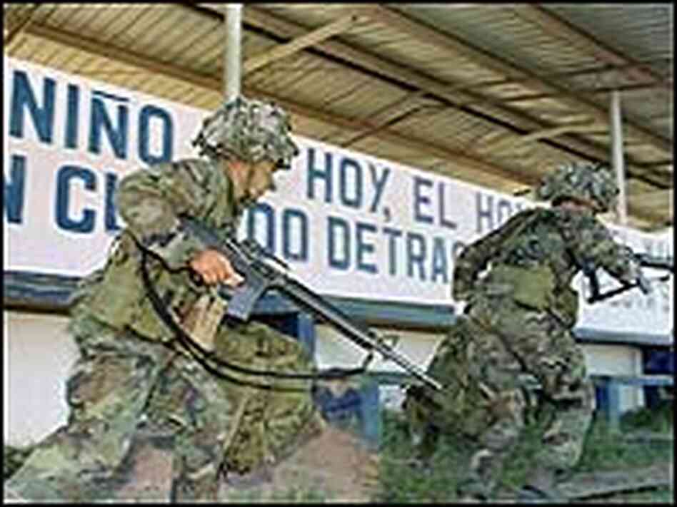 U.S. soldiers advance toward a military command post in Panama in December 1989. U.S. soldiers advance toward a military command post in Panama in December 1989.