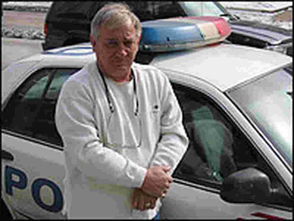 Sgt. John Brennan, a Washington DC Police Officer, standing in front of a squad car. Sgt. John Brennan, a Washington DC Police Officer, standing in front of a squad car.