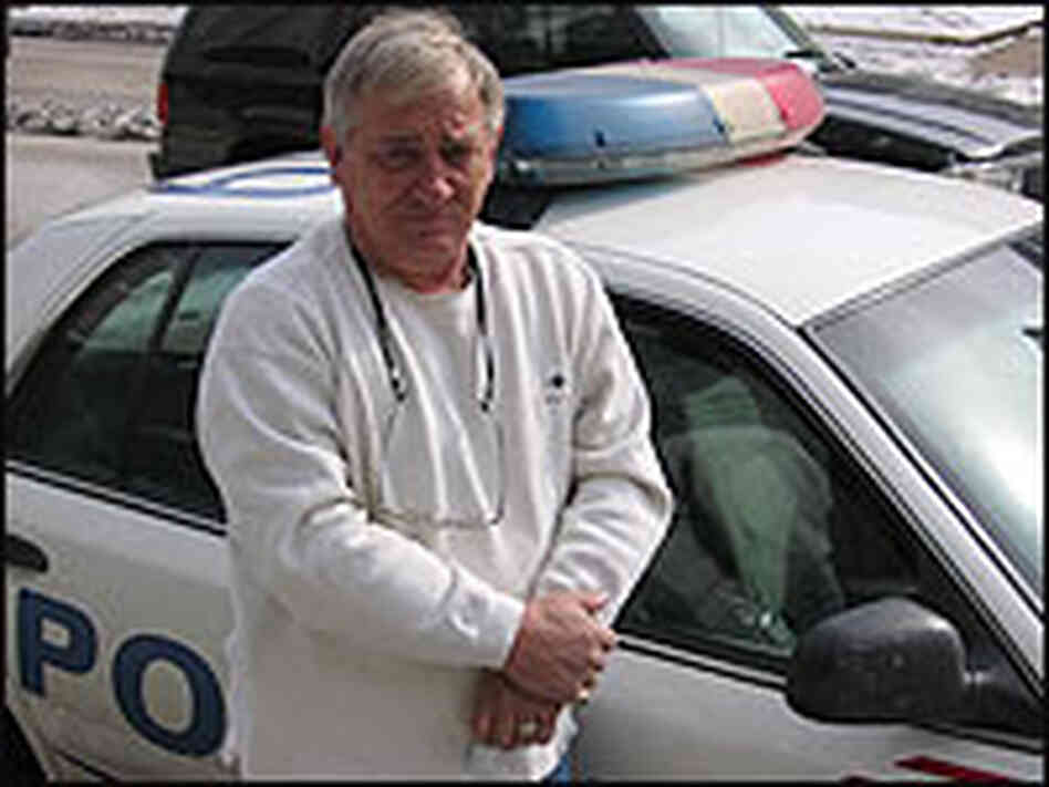 Sgt. John Brennan, a Washington DC Police Officer, standing in front of a squad car. Sgt. John Brennan, a Washington DC Police Officer, standing in front of a squad car.