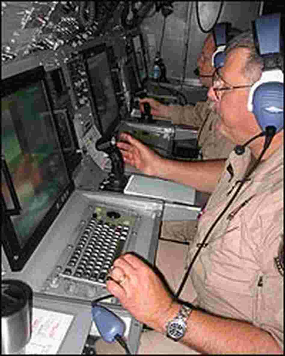 Senior Detection Systems Speicalist Dan Williams sitting at a console in a plane, using radar. Senior Detection Systems Speicalist Dan Williams sitting at a console in a plane, using radar.