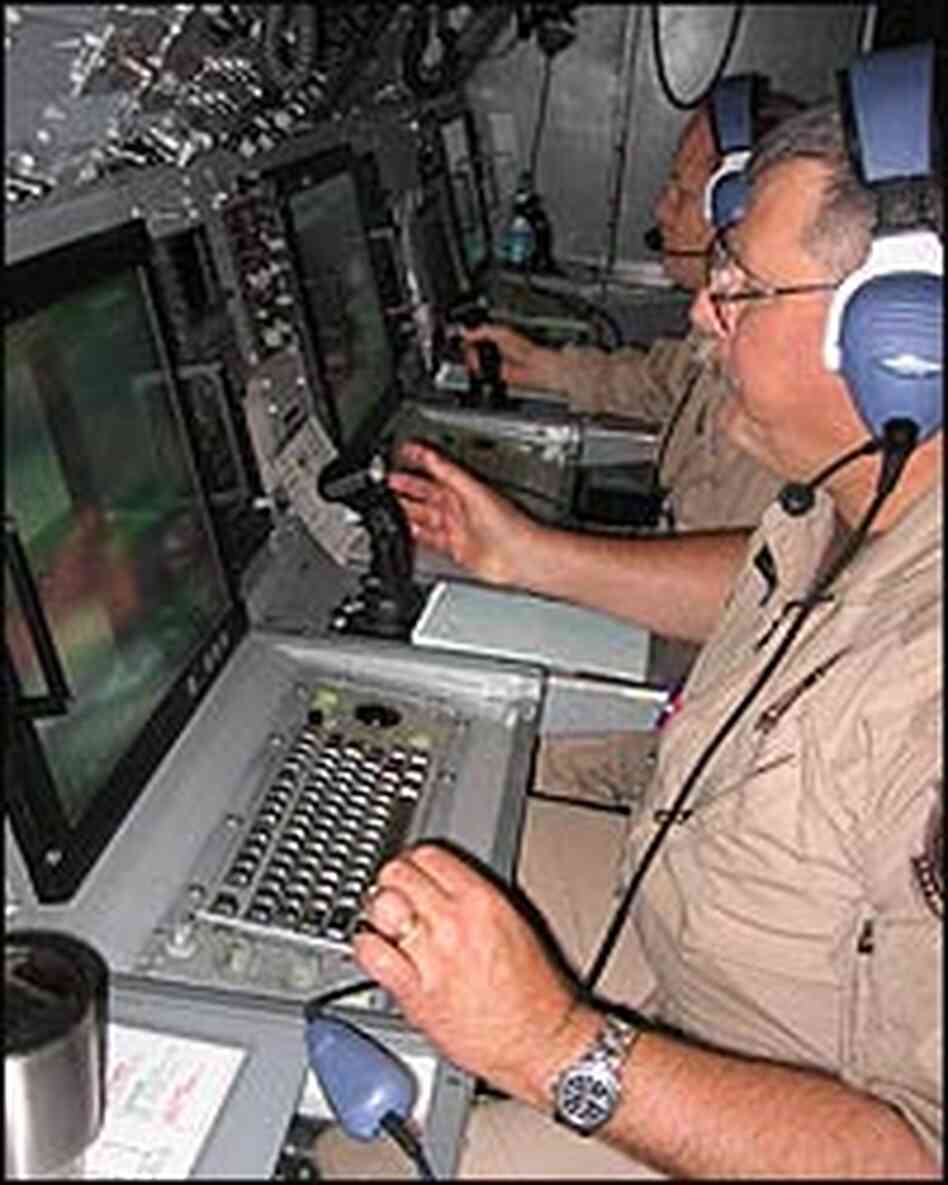 Senior Detection Systems Speicalist Dan Williams sitting at a console in a plane, using radar. Senior Detection Systems Speicalist Dan Williams sitting at a console in a plane, using radar.
