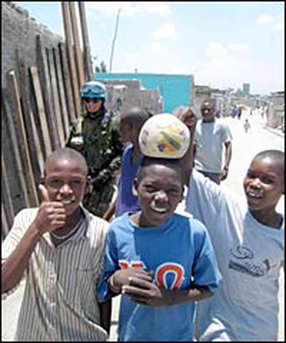 Children play around a patrol of Brazilian U.N. peacekeepers in Port-au-Prince, Haiti.