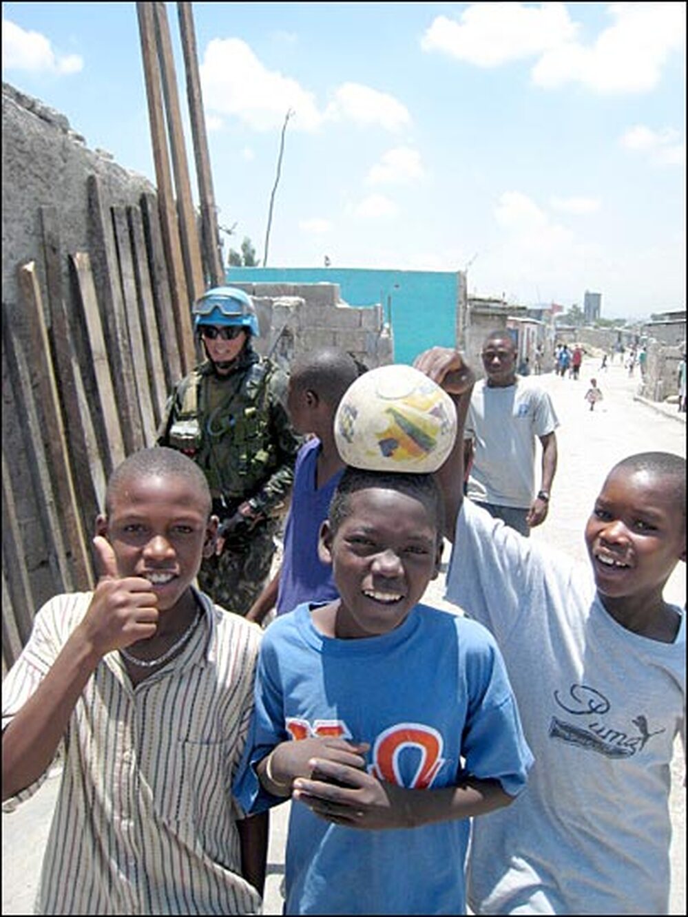 Children play around a patrol of Brazilian U.N. peacekeepers in Port-au-Prince, Haiti.