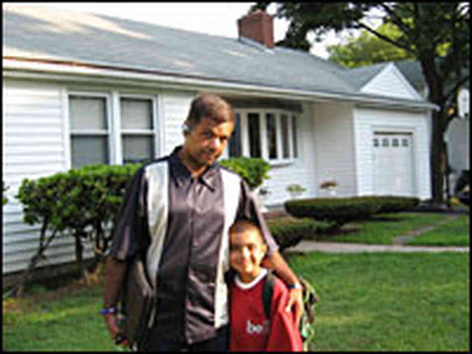 Jose Pomales and his son in front of their house
