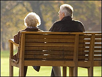 And older couple sitting on a park bench./iStockphoto.com