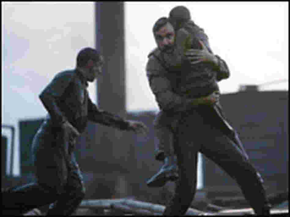 Daniel Plainview carries boy from derrick explosion.