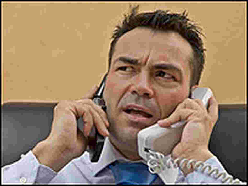 Man on two cell phones.