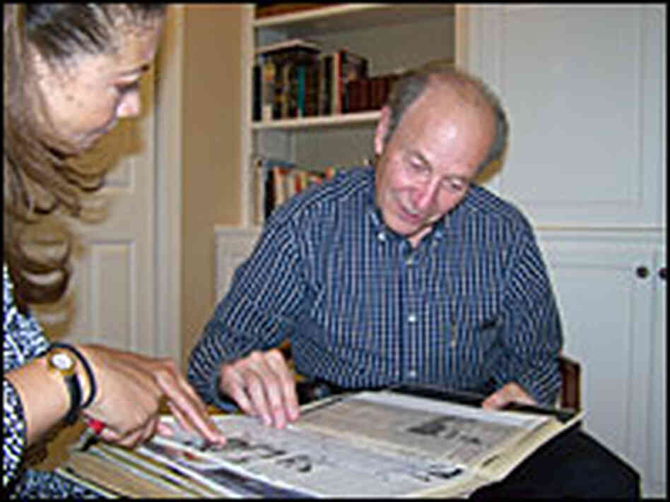 Michele Norris looks through a scrapbook with Bernard Cohen