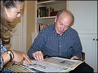Michele Norris looks through a scrapbook with Bernard Cohen