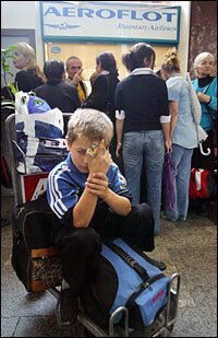 A boy waits to board a plane to Russia from the Tbilisi airport in October 2006. Moscow expelled 119 citizens of Georgia during a political confrontation with the former Soviet republic.