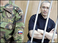 Russian tycoon Mikhail Khodorkovsky, former head of the Yukos oil company, stands in the defendant's box in a courtroom in Moscow, May 30, 2005. He was sentenced to eight years in prison; many believe he was punished for posing a political threat to Russian President Vladimir Putin.
