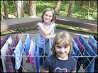 Daughters Nadia (back) and Anja stand with a rack of drying clothes on the family's deck. Daughters Nadia (back) and Anja stand with a rack of drying clothes on the family's deck.