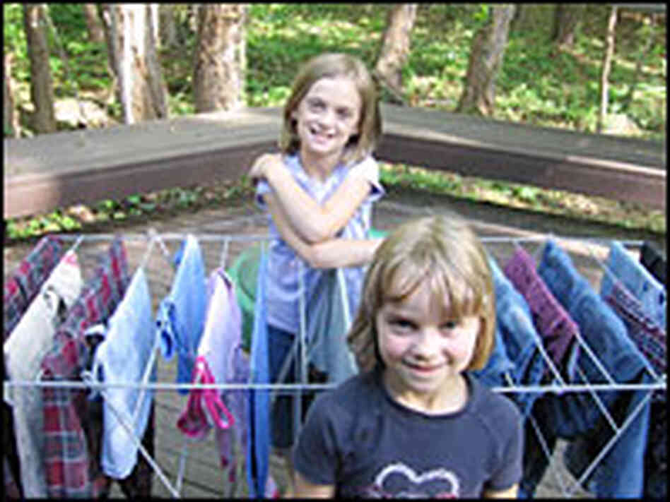 Daughters Nadia (back) and Anja stand with a rack of drying clothes on the family's deck. Daughters Nadia (back) and Anja stand with a rack of drying clothes on the family's deck.