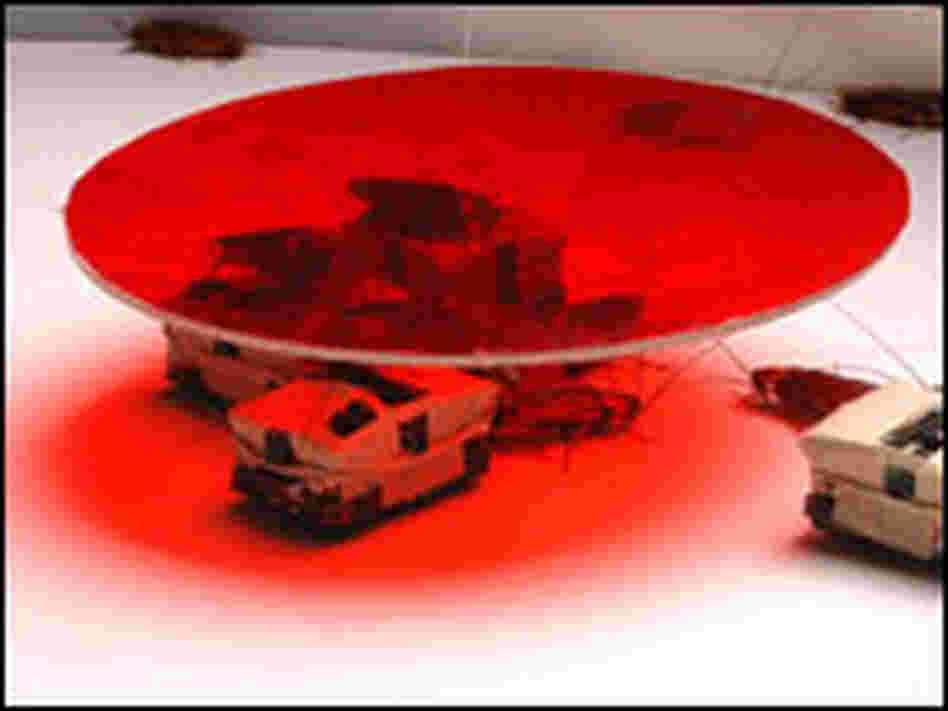 Cockroaches and robotic roaches rest under a shelter.