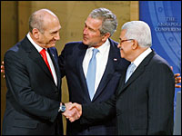 Israeli Prime Minister Ehud Olmert (left),  and Palestinian President Mahmoud Abbas (right)  shake hands as U.S. President George W. Bush stands by at the opening session of the Mideast conference in Annapolis, Md., Nov. 27, 2007.