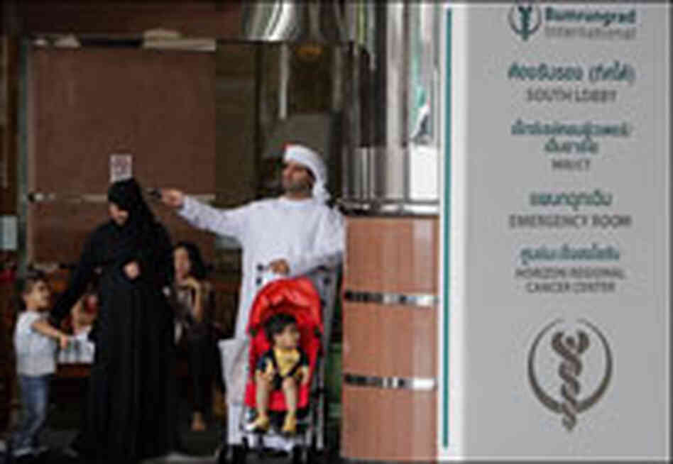 An Arab family waits outside Bumrungrad International Hospital in Bangkok.