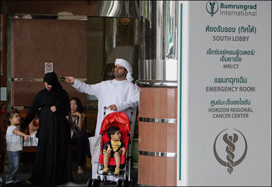 An Arab family waits outside Bumrungrad International Hospital in Bangkok.
