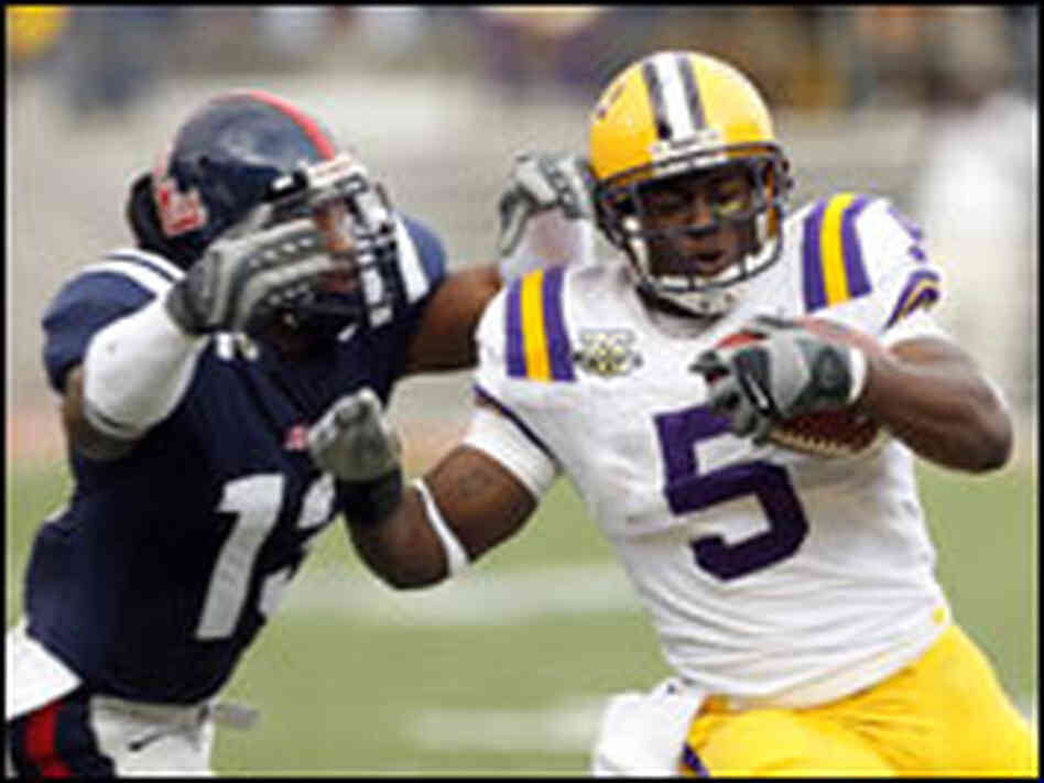 Keiland Williams of LSU runs against Jamarca Sanford