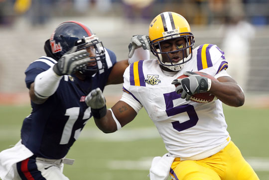 Keiland Williams of LSU runs against Jamarca Sanford