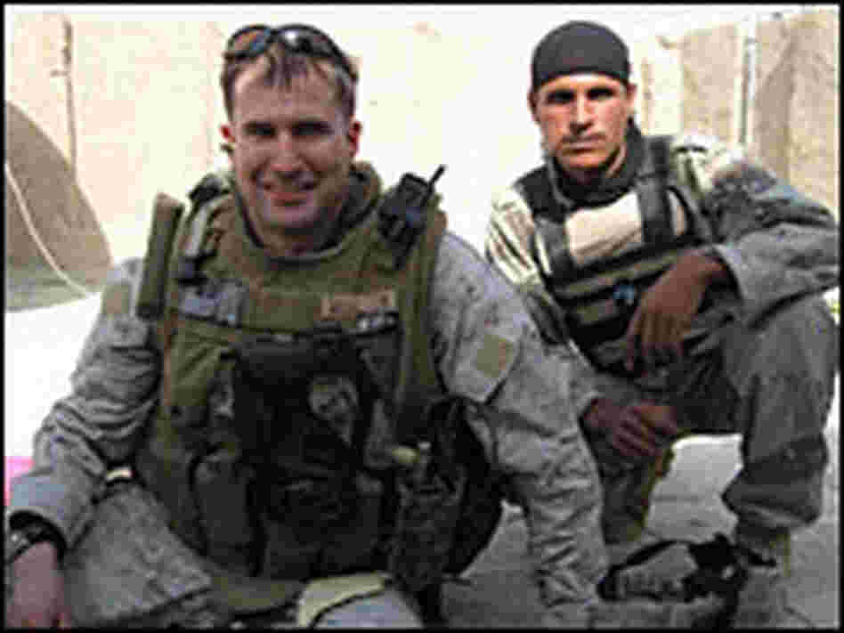 Capt. Seth Moulton and an Iraqi soldier take a break from training on a rooftop near a joint securit