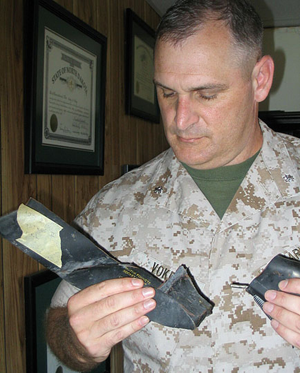 Colby Volkey holds shrapnel from the Gulf War in 1991.