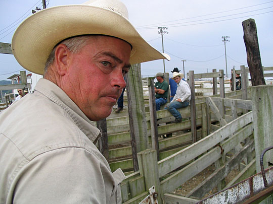Rodeo owner Grant Harris stands by the horse and bull stalls.