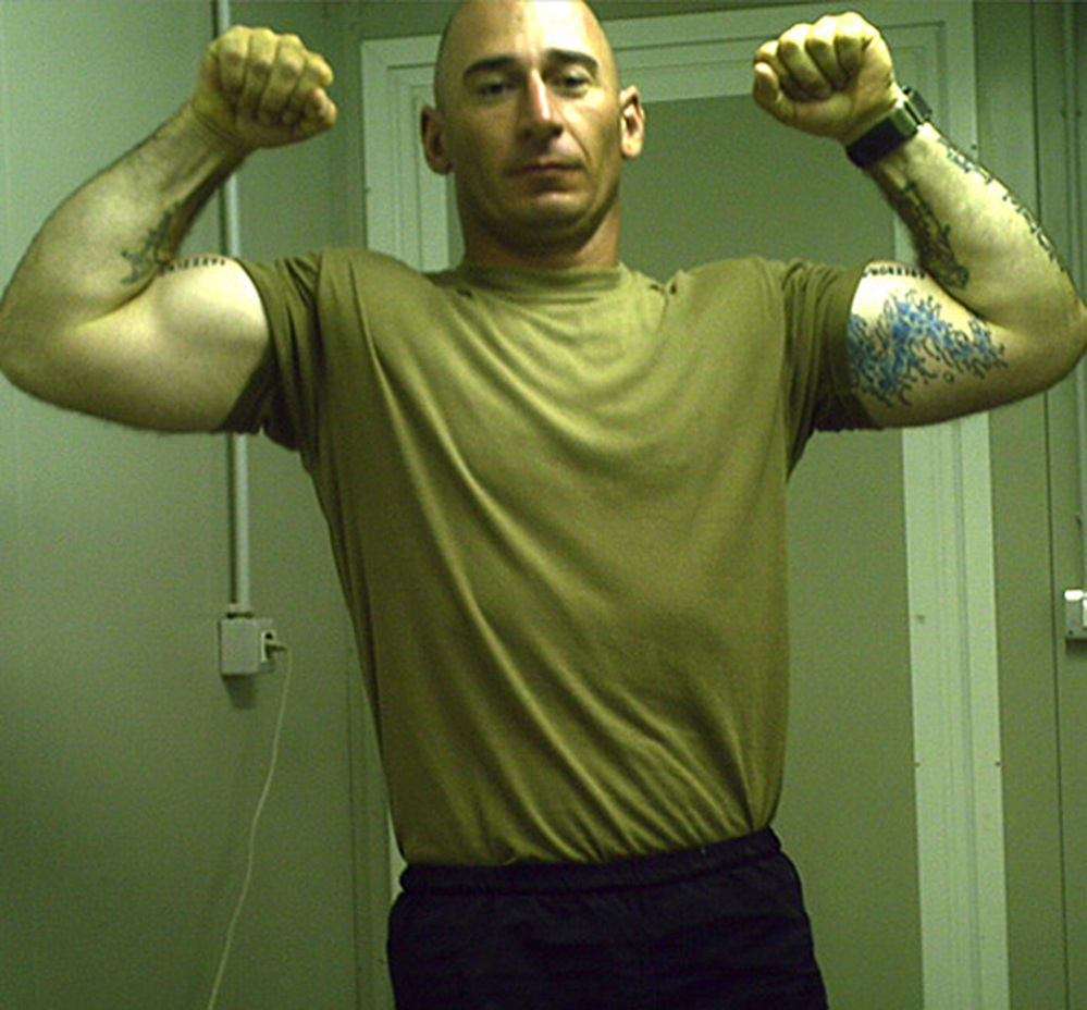 Staff Sgt. Robert Henline flexes his biceps in a photo taken in Iraq.