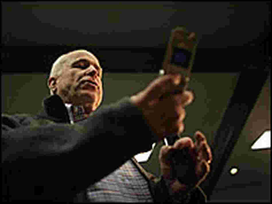 McCain looks at his cell phone.