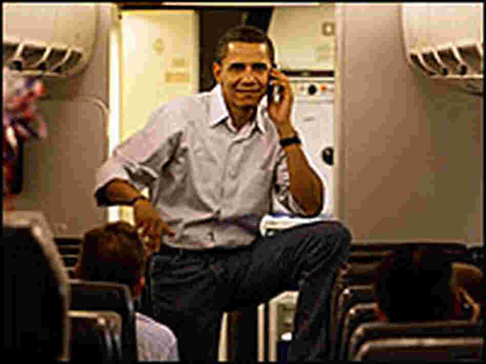 Barack Obama talks on his cell phone.