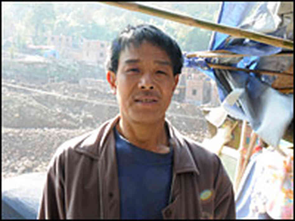 Wang Xiaoqi says his house was only slightly damaged but was torn down to build the tourist village.
