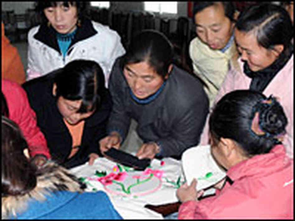 Women at the Leigu refugee camp in Sichuan province learn Qiang embroidery.