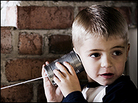 A boy listens with his tin-can phone. A boy listens with his tin-can phone.