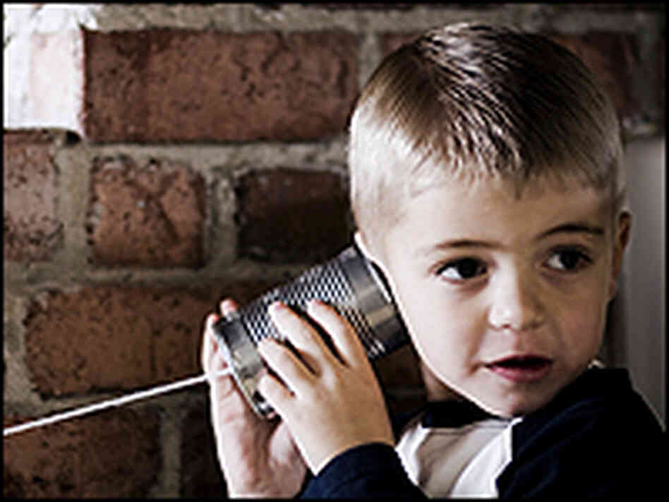 A boy listens with his tin-can phone. A boy listens with his tin-can phone.