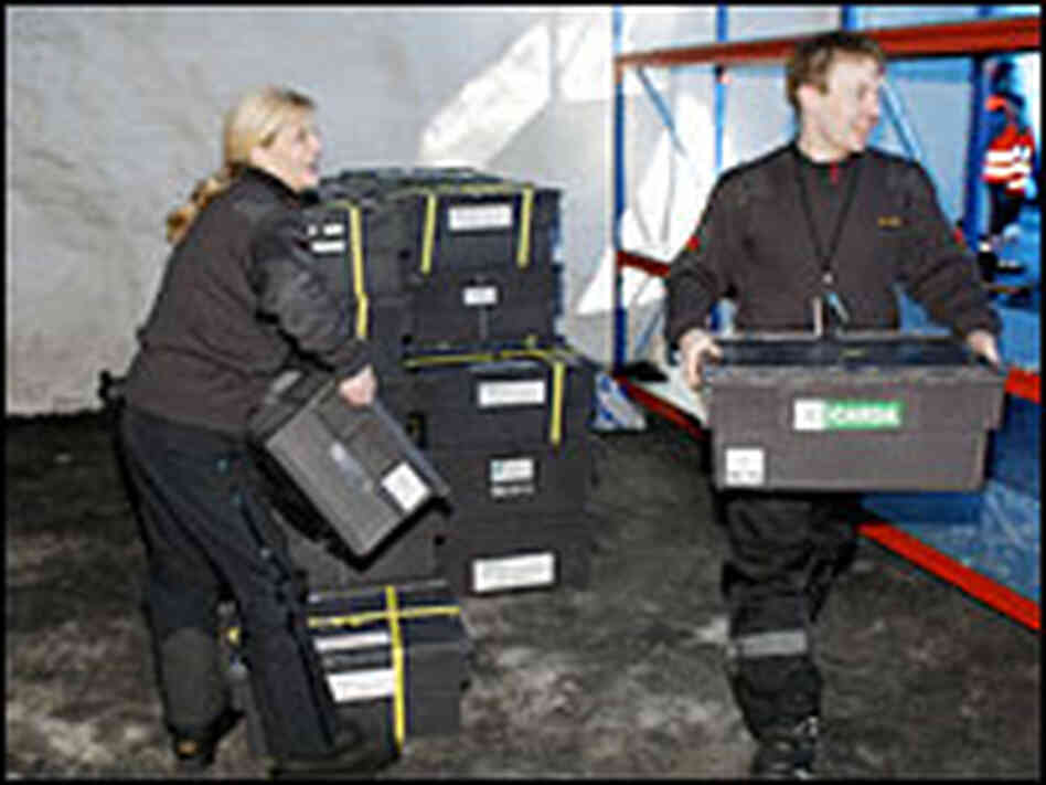 Workers carry boxes of seeds into the Svalbard Global Seed Vault after its official opening on Feb.