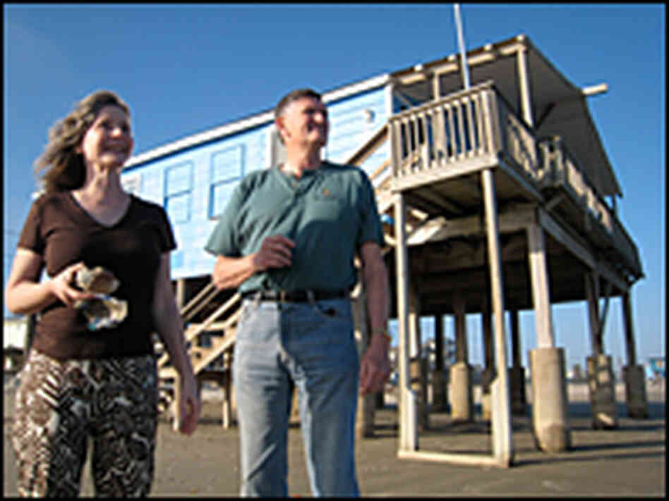 Brooks and Merry Porter in front of their home in Surfside, Texas.