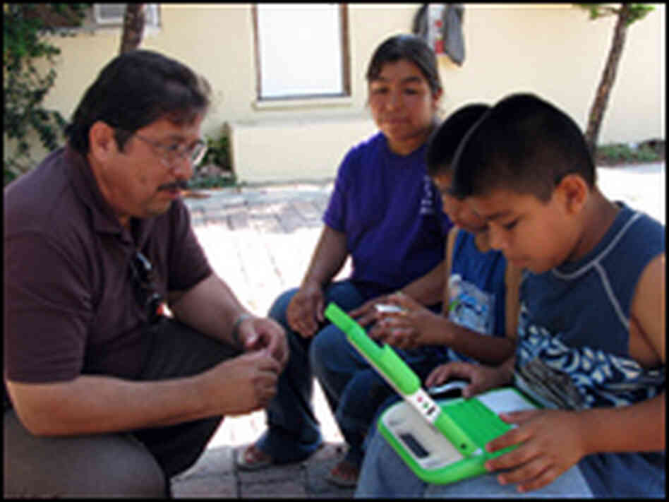 Juan Medina and Ifrain Ramas with a One Laptop Per Child computer