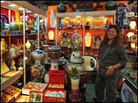 A vendor waits for customers at a shop selling Chinese goods at Dragon Mart in Dubai. A vendor waits for customers at a shop selling Chinese goods at Dragon Mart in Dubai.