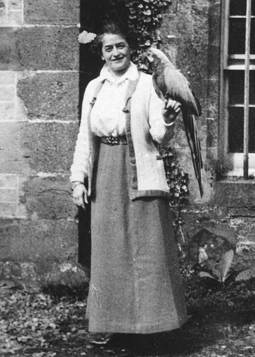 Girl Scout founder Juliette Gordon Low with a parrot.