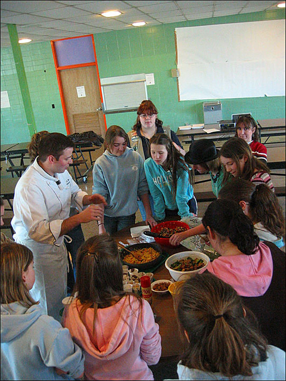 Girl Scouts learn to cook on a hot plate.