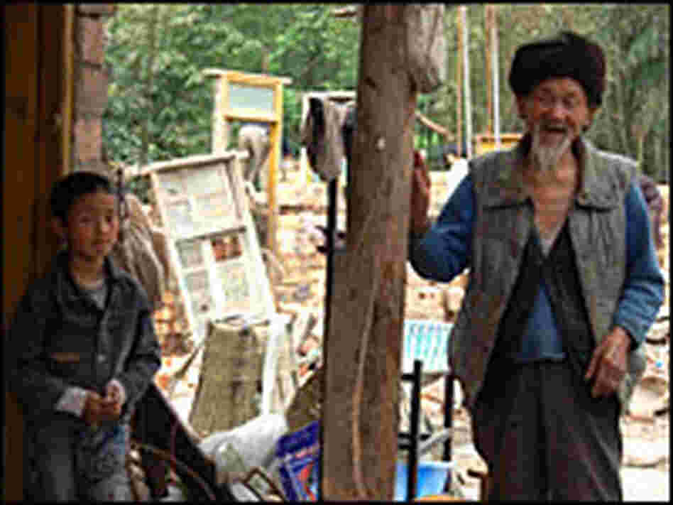 Yao Suhui's 9-year-old son, Yang Hao, stands near his 95-year-old great-grandfather.